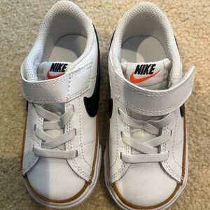 White, brown, and black toddler Nikes. Size 7c.
